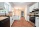 Modern kitchen with stainless steel appliances, granite countertops, and wood flooring at 372 Rustic Ridge Cir, Lawrenceville, GA 30043