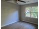 Bright bedroom with wood-look flooring, fan with light fixture, and double window at 409 Arbor Ridge Dr, Stone Mountain, GA 30087