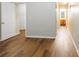 An upstairs hallway featuring hard wood floors, with entrances to various rooms at 612 Stadler Pointe, Mcdonough, GA 30253