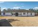 Rear of home featuring white siding, black trim, and a well-maintained lawn at 1243 Old Villa Rica Rd, Dallas, GA 30157
