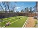 Turf backyard with a fence, ideal for ' play, with an AC unit and gravel area at 1243 Old Villa Rica Rd, Dallas, GA 30157