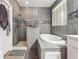 Modern bathroom featuring a glass-enclosed shower, soaking tub, and stylish gray wood-look tile at 1243 Old Villa Rica Rd, Dallas, GA 30157