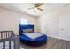 Bright bedroom featuring a round blue bed, wood floors, and large window at 1243 Old Villa Rica Rd, Dallas, GA 30157