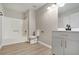 Clean bathroom with white shower-tub, gray vanity with black faucet, and modern lighting at 2940 Leah Ln, Douglasville, GA 30135