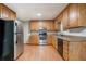 Well-lit kitchen features stainless steel refrigerator, wooden cabinetry, and a stainless steel oven at 2940 Leah Ln, Douglasville, GA 30135