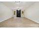 The expansive living room features a decorative black fireplace, two windows and light wood floors at 2940 Leah Ln, Douglasville, GA 30135