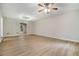 Spacious living room with wood-look floors, neutral paint, and classic ceiling fan at 2940 Leah Ln, Douglasville, GA 30135