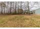 Exterior shot of large grass backyard showing mature trees and house at 116 Black Oak Ct, Stockbridge, GA 30281