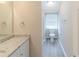 Bright bathroom featuring a granite countertop vanity and a toilet beneath a window at 116 Black Oak Ct, Stockbridge, GA 30281