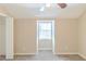 Bedroom features neutral walls, carpet, a ceiling fan, and a bright window at 116 Black Oak Ct, Stockbridge, GA 30281