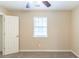 Bedroom with a ceiling fan, window, and a closet door at 116 Black Oak Ct, Stockbridge, GA 30281