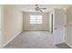 Bedroom with a ceiling fan, carpet, neutral walls, and natural light from the window at 116 Black Oak Ct, Stockbridge, GA 30281