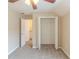 Cozy bedroom with neutral walls, a ceiling fan, carpet, and ensuite closet access at 116 Black Oak Ct, Stockbridge, GA 30281