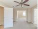 A bright bonus room includes a ceiling fan and neutral carpeting at 116 Black Oak Ct, Stockbridge, GA 30281