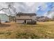 Exterior view of a two-story home showcasing a large yard and a wood deck at 116 Black Oak Ct, Stockbridge, GA 30281