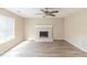 Bright living room features a brick fireplace, ceiling fan, and large window providing natural light at 116 Black Oak Ct, Stockbridge, GA 30281