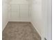 A spacious walk-in closet features installed shelving and neutral carpeting at 116 Black Oak Ct, Stockbridge, GA 30281