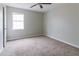 Comfortable bedroom with plush carpet and bright natural light from the window at 2172 Red Rose Ln, Loganville, GA 30052