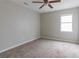 Cozy bedroom with plush carpeting, ceiling fan and natural light from a window at 2172 Red Rose Ln, Loganville, GA 30052