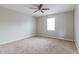 Serene bedroom featuring soft carpet, neutral walls, and a ceiling fan at 2172 Red Rose Ln, Loganville, GA 30052