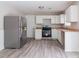 Functional kitchen featuring stainless steel appliances, white cabinets, and durable countertops at 2172 Red Rose Ln, Loganville, GA 30052