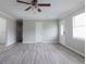 Open-concept living room with laminate floors, natural light, and neutral paint at 2172 Red Rose Ln, Loganville, GA 30052