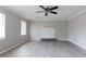 Bright living room with a ceiling fan, grey laminate flooring, and a decorative fireplace at 2172 Red Rose Ln, Loganville, GA 30052