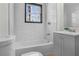 Bathroom featuring a tiled shower-tub, a vanity, and updated fixtures at 391 S Bend Se Ave, Atlanta, GA 30315