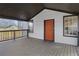 Charming front porch featuring a modern orange front door and dark trim windows at 391 S Bend Se Ave, Atlanta, GA 30315