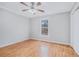 This cozy bedroom features beautiful wood floors, a ceiling fan, and a bright window at 441 Village Way, Lawrenceville, GA 30046