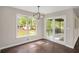 Bright dining area with hardwood floors, modern light fixture, a large window, and access to outdoor deck at 4902 Cedar Se Ct, Conyers, GA 30094