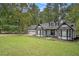 Charming one-story home featuring white siding, black trim, a covered porch, and an attached two car garage at 4902 Cedar Se Ct, Conyers, GA 30094