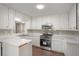 Bright kitchen with white cabinets, stainless steel appliances, granite countertops, and hardwood flooring at 4902 Cedar Se Ct, Conyers, GA 30094