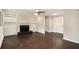 Spacious living room featuring hardwood floors, a fireplace with built-in shelving, and decorative glass pane front doors at 4902 Cedar Se Ct, Conyers, GA 30094