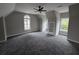 Neutral carpeted bedroom with a ceiling fan and unique wall accents at 7910 Tintern Trce, Duluth, GA 30097