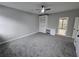 Neutral bedroom with a ceiling fan, built in desk and shelving, and an ensuite bathroom at 7910 Tintern Trce, Duluth, GA 30097