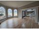 Sunlit living room with large windows, hardwood floors, and elegant trim work at 7910 Tintern Trce, Duluth, GA 30097