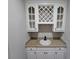 Stylish wet bar features white cabinets, wine rack, and sink at 7910 Tintern Trce, Duluth, GA 30097