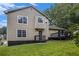 Exterior shot of home featuring a rear deck, a well-maintained lawn, and mature trees at 8740 Parliament Pl, Jonesboro, GA 30238