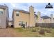 Virtually staged backyard patio and fire pit area with yellow vinyl siding and fenced perimeter at 11143 Aliyah Dr, Hampton, GA 30228