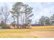 View of the expansive backyard, surrounded by tall trees and a wooden fence at 11143 Aliyah Dr, Hampton, GA 30228