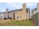 Backyard showing the fence line, yellow vinyl siding, and small concrete patio with a grassy area at 11143 Aliyah Dr, Hampton, GA 30228