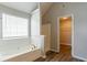 Bathroom featuring a tub, walk-in shower, and a large window at 11143 Aliyah Dr, Hampton, GA 30228
