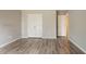 This bedroom has neutral paint and wood-look flooring plus a bi-fold door closet at 11143 Aliyah Dr, Hampton, GA 30228