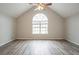 An empty bedroom featuring vaulted ceilings, ceiling fan and light gray wood floors at 11143 Aliyah Dr, Hampton, GA 30228