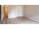 This bedroom has a closet with white bi-fold doors and wood-look flooring at 11143 Aliyah Dr, Hampton, GA 30228