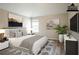 Staged bedroom with artwork, gray walls, wood floors, and a modern bed at 11143 Aliyah Dr, Hampton, GA 30228