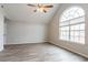 Bright bedroom featuring vaulted ceilings, ceiling fan and light gray wood floors at 11143 Aliyah Dr, Hampton, GA 30228
