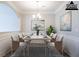 Elegant dining room featuring modern chandelier, artwork, and seating for six at 11143 Aliyah Dr, Hampton, GA 30228