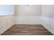 An empty dining room featuring wainscotting, light gray walls, and wood floors at 11143 Aliyah Dr, Hampton, GA 30228